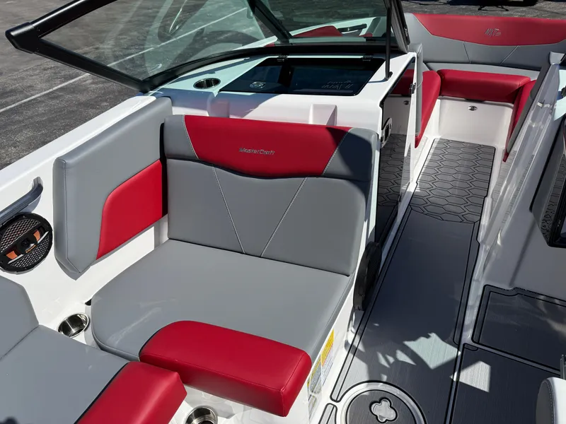 Slide: The Image of 2025 MasterCraft NXT22 boat interior with red and gray seating, modern design. - 23