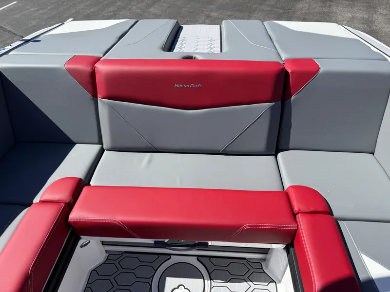 Slide: The Image of 2025 MasterCraft NXT22 boat interior with red and gray seating, showcasing modern design. - 29