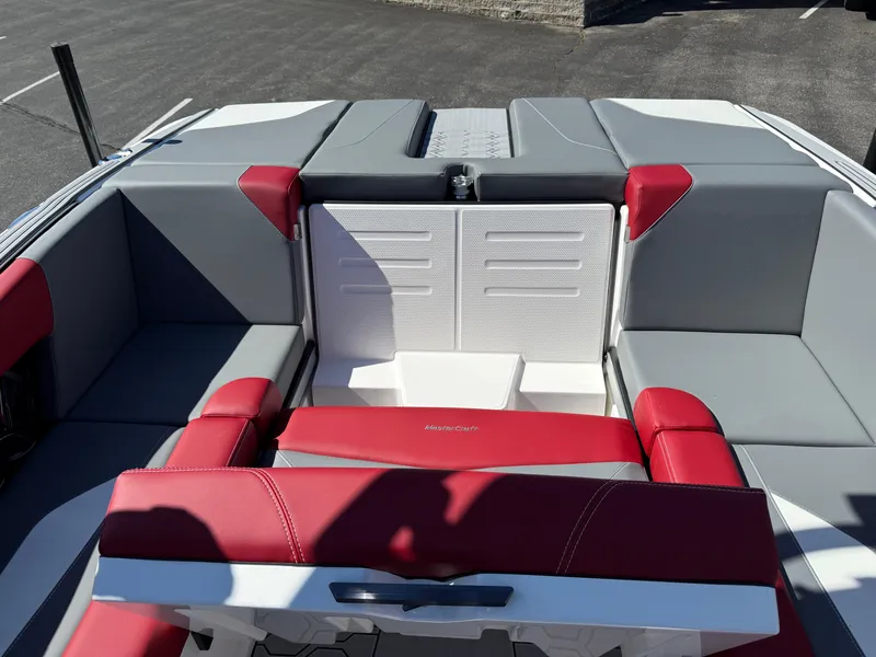 Slide: The Image of 2025 MasterCraft NXT22 boat interior with red and gray seating, showcasing modern design. - 30