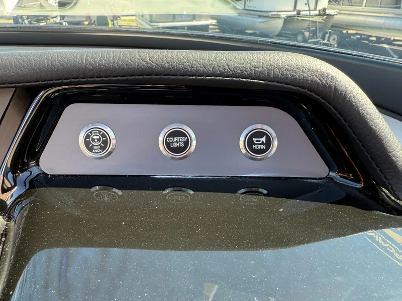 Slide: The Image of Dashboard controls of 2025 MasterCraft NXT22 boat, featuring navigation, lights, and horn buttons. - 35