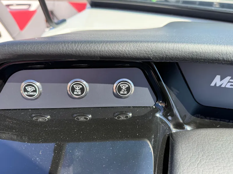 Slide: The Image of Dashboard controls of 2025 MasterCraft NXT22 boat, featuring blower and bilge switches. - 36