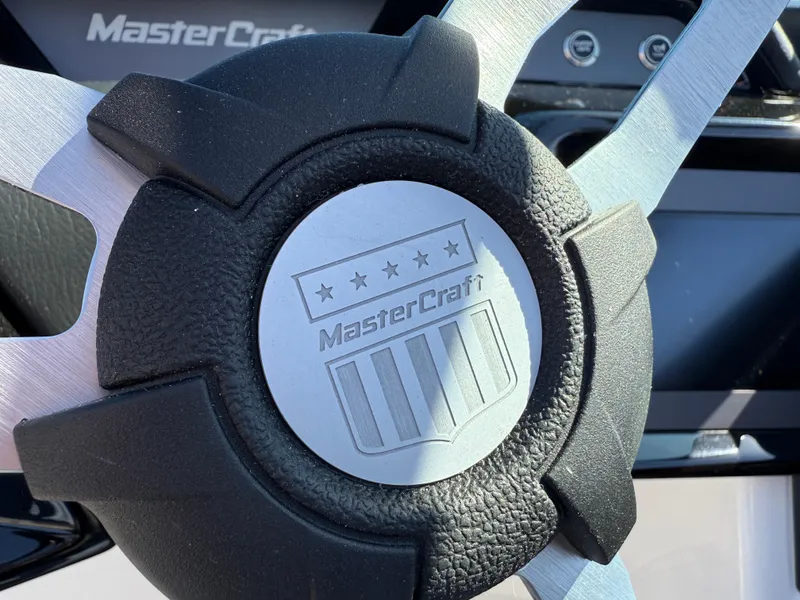 Slide: The Image of Close-up of 2025 MasterCraft NXT22 steering wheel with logo and emblem. - 37
