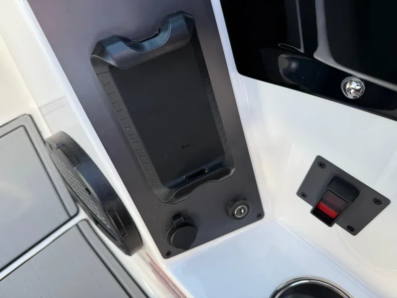 Slide: The Image of Control panel of 2025 MasterCraft NXT22 boat with phone holder and switches. - 39