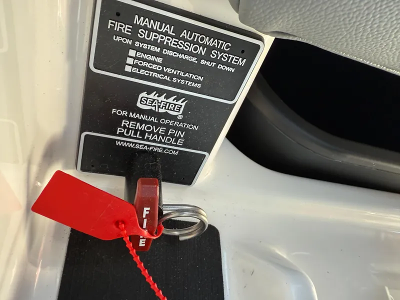 Slide: The Image of Manual fire suppression system in 2025 MasterCraft NXT22 boat with red safety pin. - 41