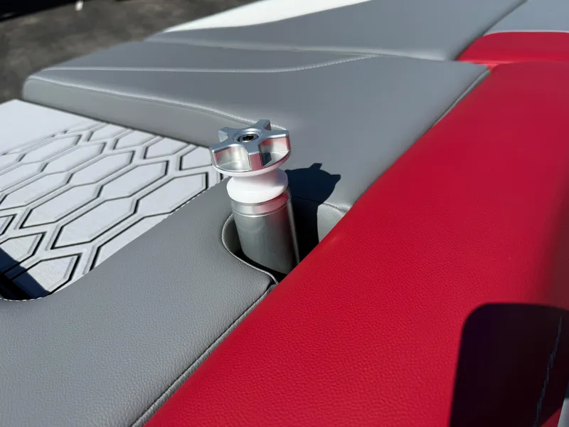 Slide: The Image of Close-up of 2025 MasterCraft NXT22 boat seat with red and gray upholstery. - 42
