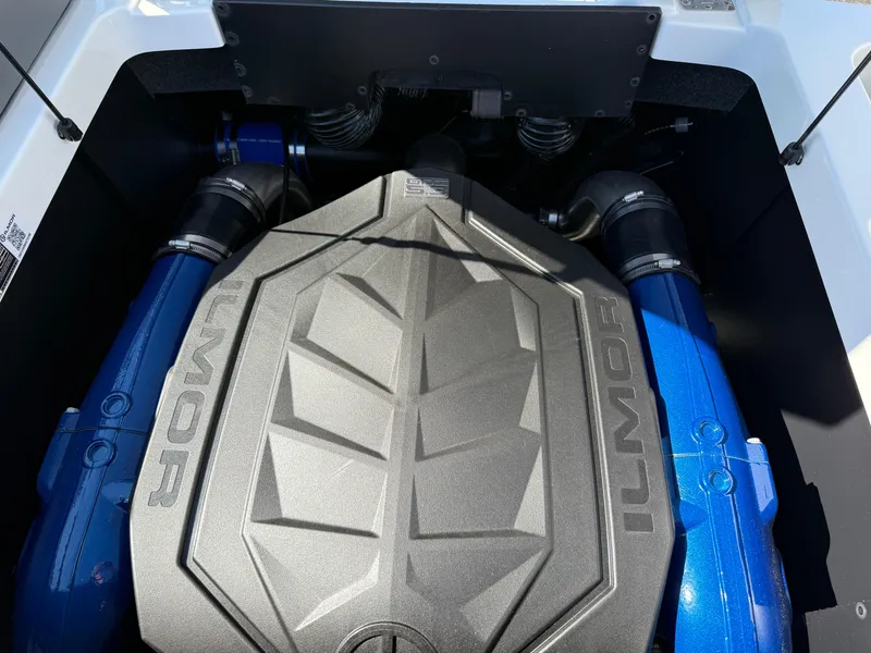 Slide: The Image of 2025 MasterCraft NXT22 Ilmor engine with blue accents in boat compartment. - 44