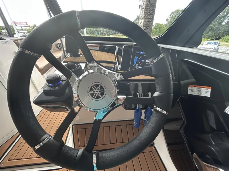 Slide: The Image of 2024 Yamaha Boats 222 S steering wheel and dashboard interior view. - 5