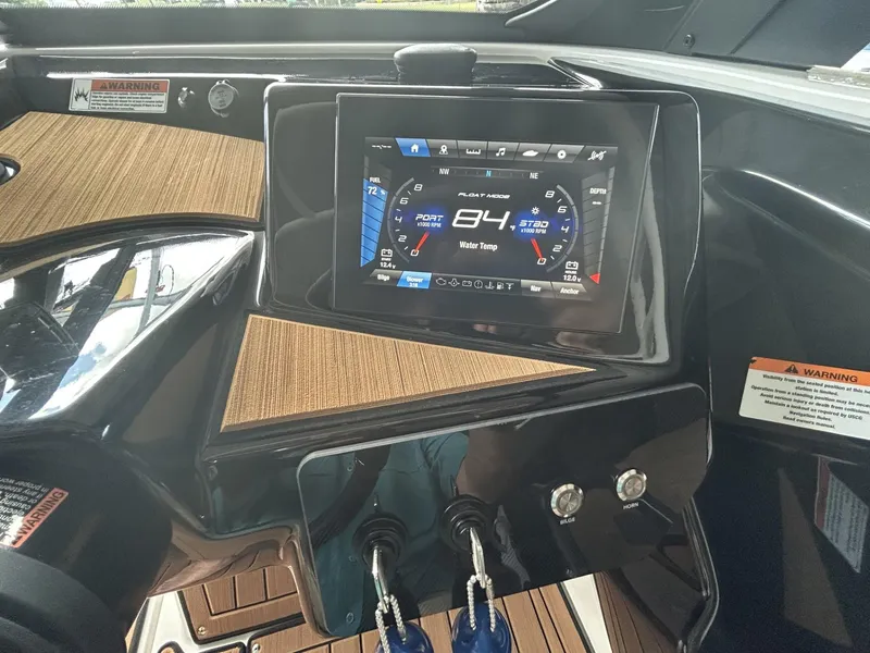 Slide: The Image of 2024 Yamaha Boats 222 S dashboard with digital display and control panel. - 7