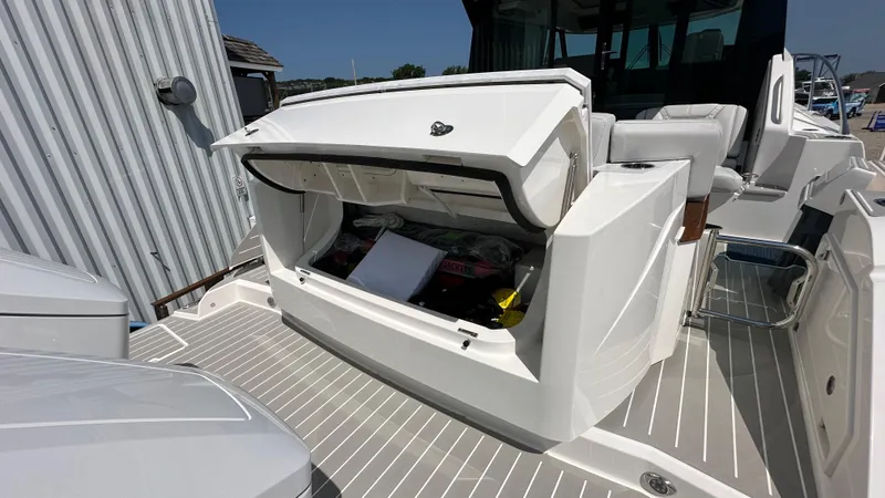 Slide: The Image of 2026 Tiara Yachts 43 LE with open storage compartment on deck. - 10