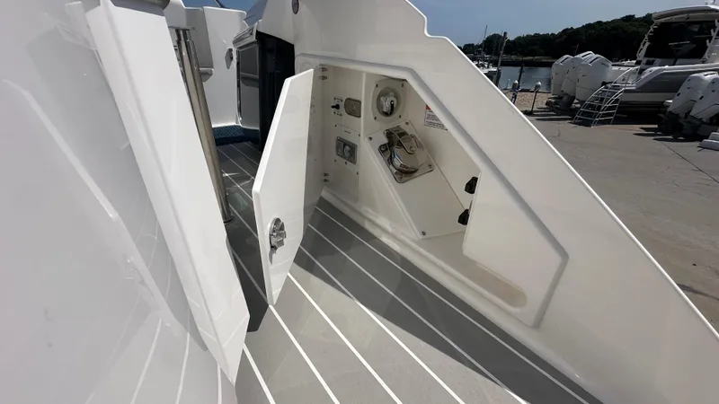 Slide: The Image of 2026 Tiara Yachts 43 LE showing open storage compartment on deck. - 11