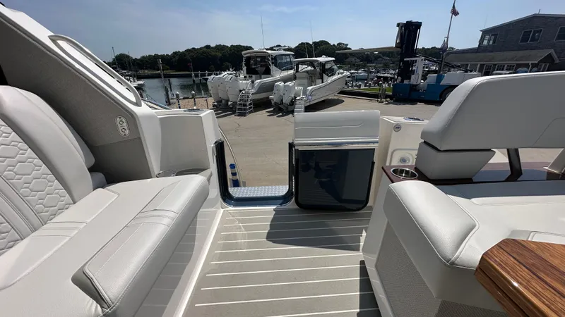 Slide: The Image of 2026 Tiara Yachts 43 LE interior with luxurious seating and marina view. - 13