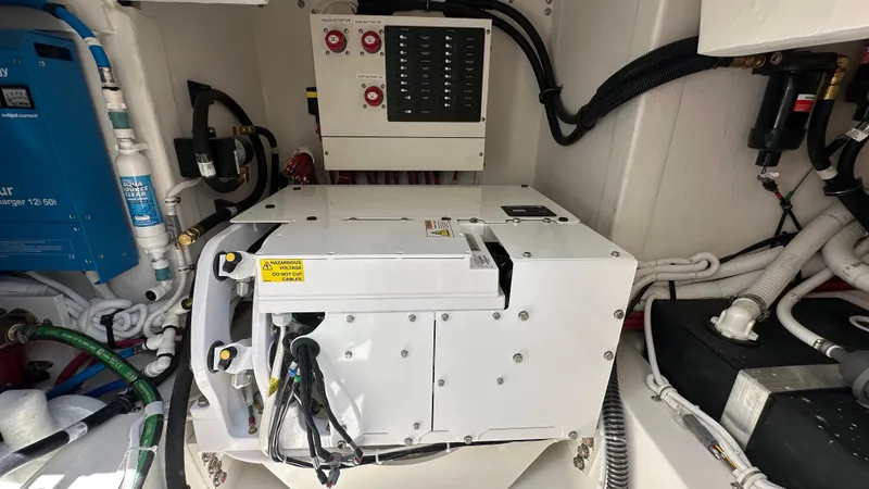 Slide: The Image of Engine room of 2026 Tiara Yachts 43 LE, showcasing electrical systems and components. - 17