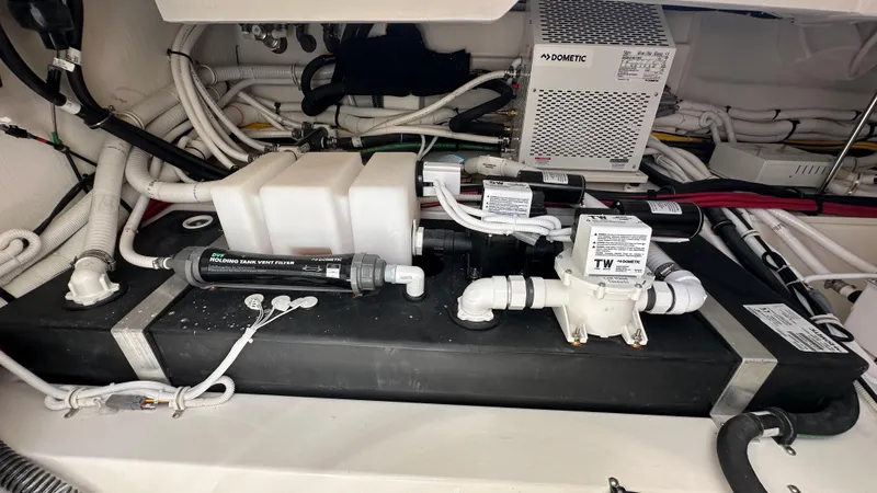 Slide: The Image of Engine room of 2026 Tiara Yachts 43 LE, showcasing plumbing and filtration systems. - 19