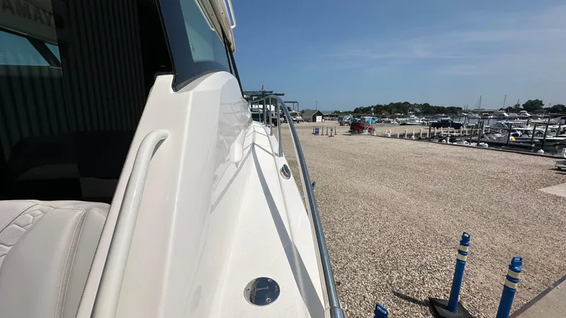 Slide: The Image of 2026 Tiara Yachts 43 LE docked at a marina under clear blue skies. - 20