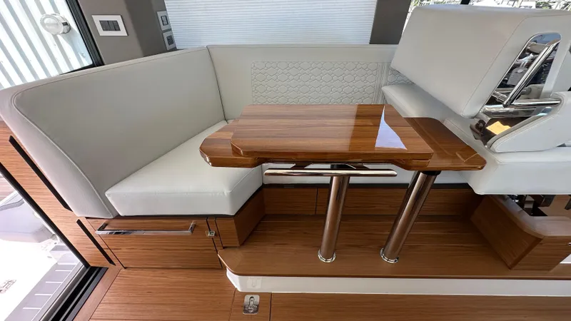 Slide: The Image of Luxurious interior seating and table on 2026 Tiara Yachts 43 LE. - 24