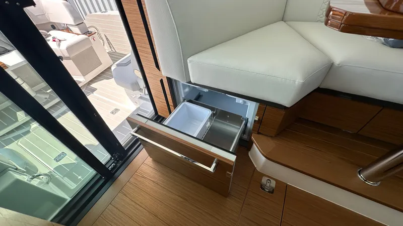 Slide: The Image of Interior of 2026 Tiara Yachts 43 LE with open drawer and seating area. - 25