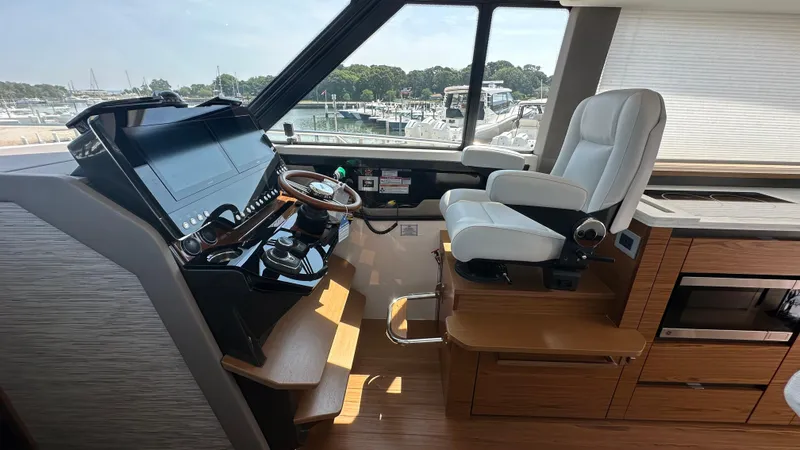 Slide: The Image of Helm station of 2026 Tiara Yachts 43 LE with modern controls and luxurious seating. - 30