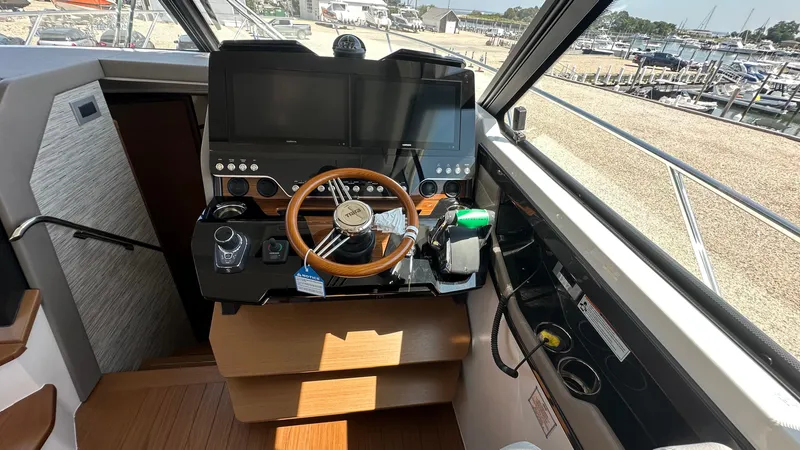 Slide: The Image of 2026 Tiara Yachts 43 LE helm with modern controls and dual screens. - 32