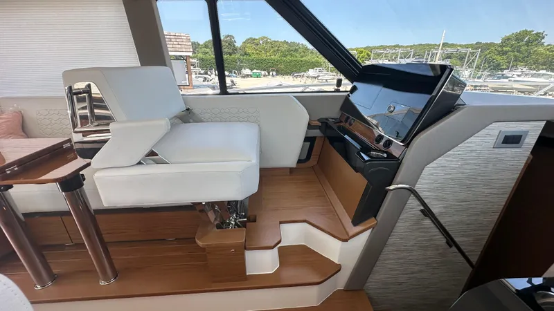 Slide: The Image of Interior of 2026 Tiara Yachts 43 LE, featuring helm station and seating. - 33
