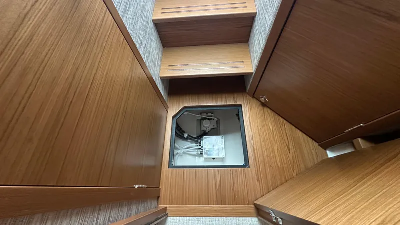 Slide: The Image of Interior view of 2026 Tiara Yachts 43 LE, featuring wooden cabinetry and access panel. - 39