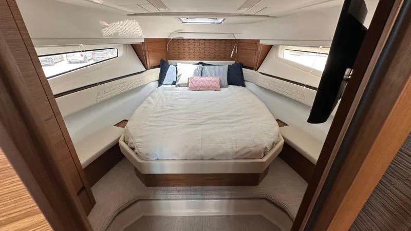 Slide: The Image of Luxurious cabin interior of 2026 Tiara Yachts 43 LE with elegant bedding and wood accents. - 40