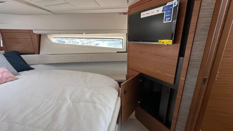 Slide: The Image of 2026 Tiara Yachts 43 LE cabin interior with bed, window, and TV. - 42