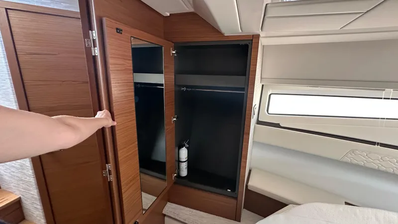 Slide: The Image of Interior of 2026 Tiara Yachts 43 LE, featuring a wooden wardrobe and window. - 44