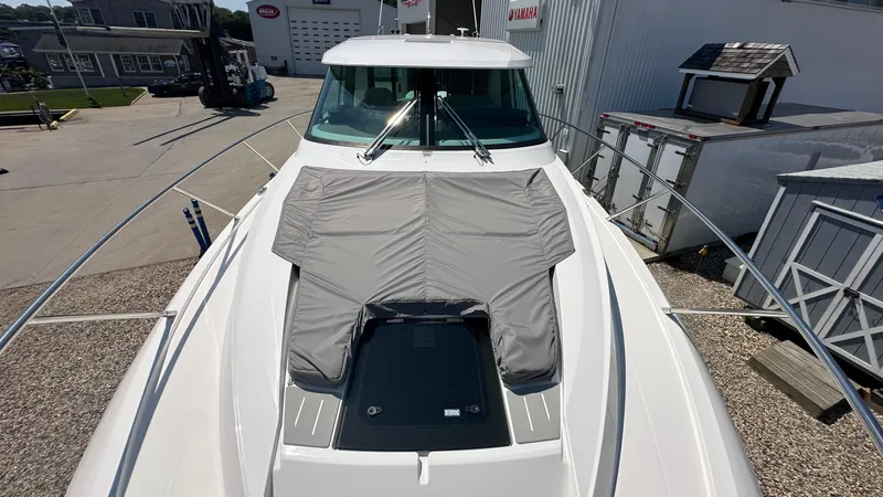 Slide: The Image of 2026 Tiara Yachts 43 LE boat with covered deck, docked at marina. - 47