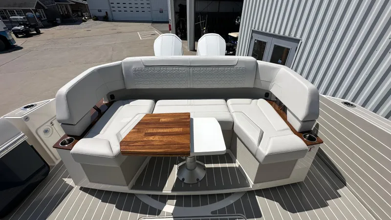 Slide: The Image of Luxurious seating area on 2026 Tiara Yachts 43 LE with wooden table and cup holders. - 5