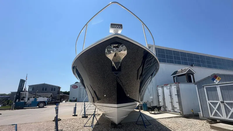 Slide: The Image of 2026 Tiara Yachts 43 LE on display at a marina under clear blue skies. - 56