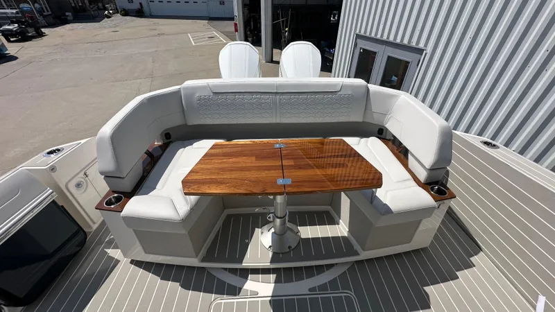 Slide: The Image of 2026 Tiara Yachts 43 LE with elegant seating and wooden table on deck. - 6