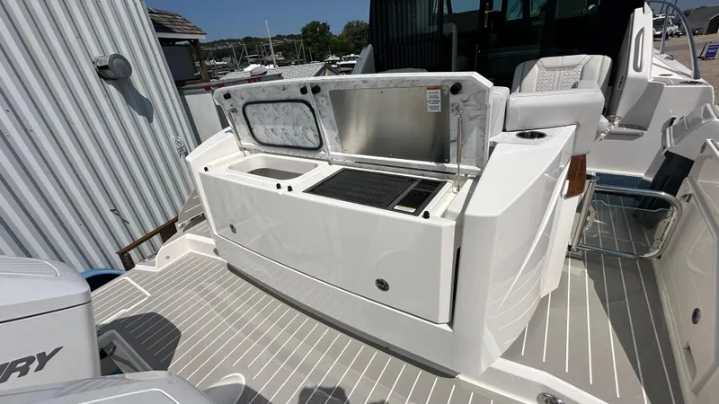 Slide: The Image of 2026 Tiara Yachts 43 LE boat deck with outdoor kitchen and seating area. - 8