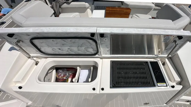 Slide: The Image of 2026 Tiara Yachts 43 LE outdoor kitchen with grill and storage compartments. - 9