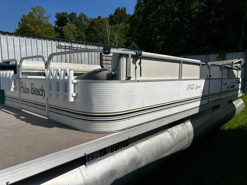 Slide: The Image of 2007 Palm Beach Sport Cruise 2423 pontoon boat docked outdoors. - 1