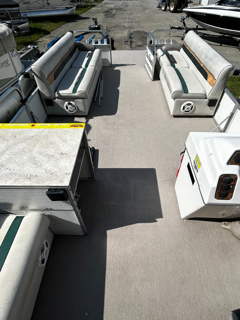 Slide: The Image of 2007 Palm Beach Sport Cruise 2423 interior with seating and storage compartments. - 7