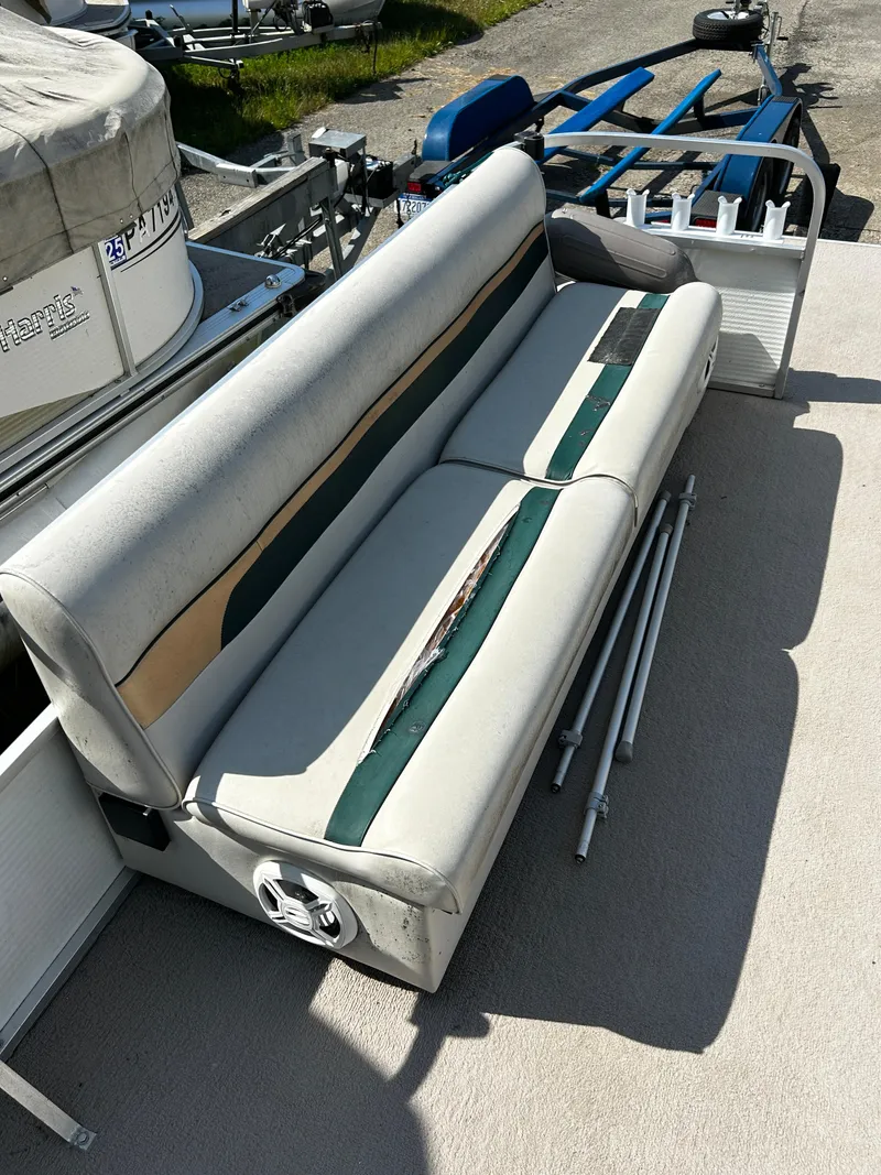 Slide: The Image of Worn seating on 2007 Palm Beach Sport Cruise 2423 boat, with visible damage and metal poles nearby. - 9