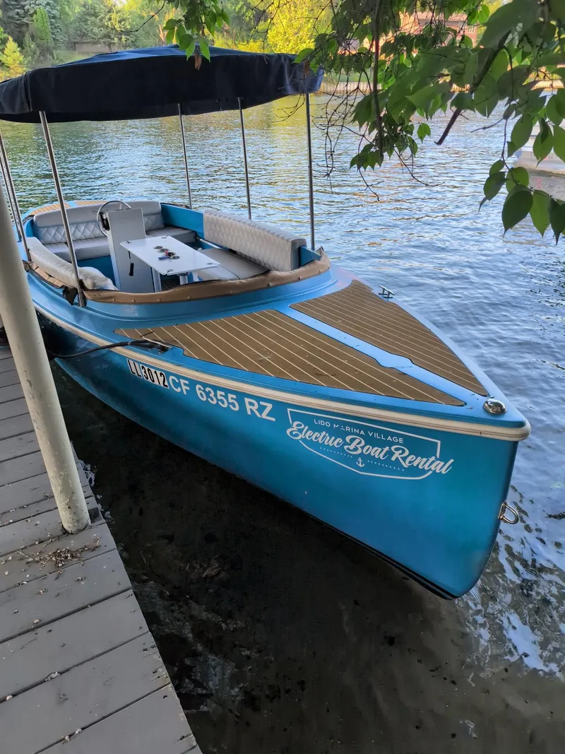 Slide: The Image of 2019 Vision Marine Technologies Fantail 217 electric boat docked by the water. - 1