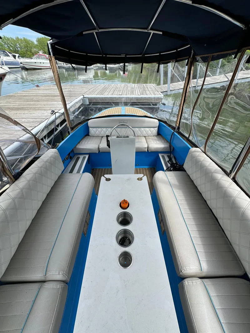 Slide: The Image of 2019 Vision Marine Technologies Fantail 217 boat with blue interior and canopy at dock. - 12