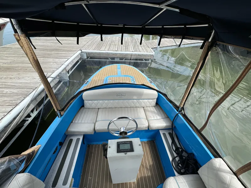Slide: The Image of 2019 Vision Marine Technologies Fantail 217 boat interior with blue accents and white seating. - 13