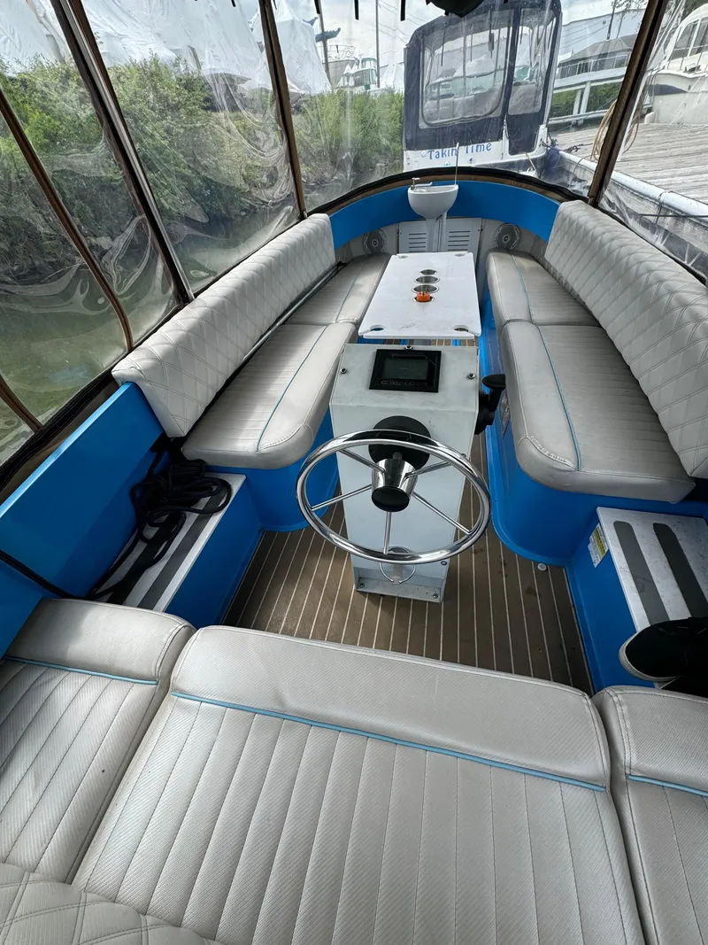 Slide: The Image of 2019 Vision Marine Technologies Fantail 217 boat interior with blue accents and seating. - 14