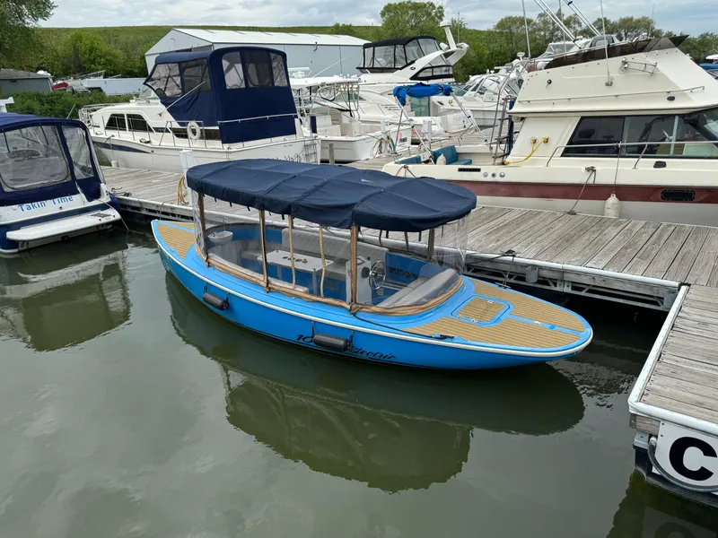 Slide: The Image of 2019 Vision Marine Technologies Fantail 217 boat docked at marina with blue canopy. - 5