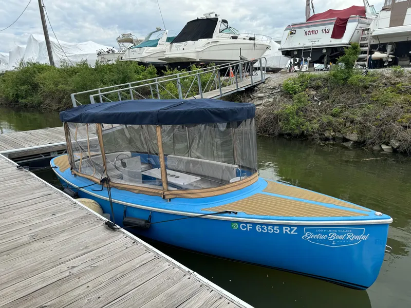 Slide: The Image of 2019 Vision Marine Technologies Fantail 217 electric boat docked by the water. - 8