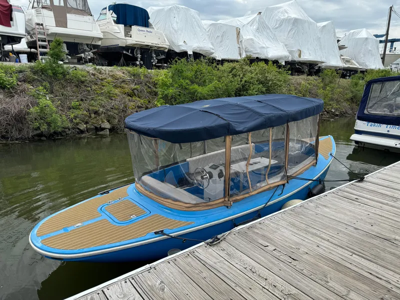 Slide: The Image of 2019 Vision Marine Technologies Fantail 217 boat docked, featuring blue canopy and clear side panels. - 9
