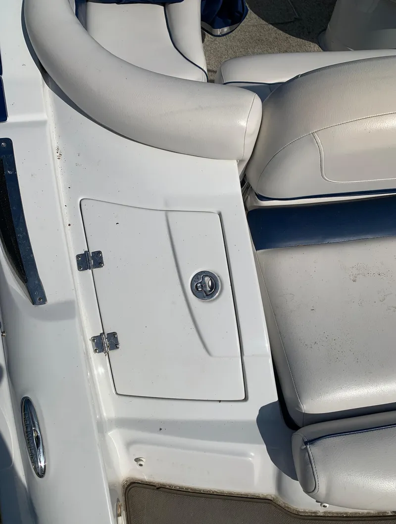 Slide: The Image of 2012 Crownline Eclipse E4 boat interior with white seating and storage compartment. - 4
