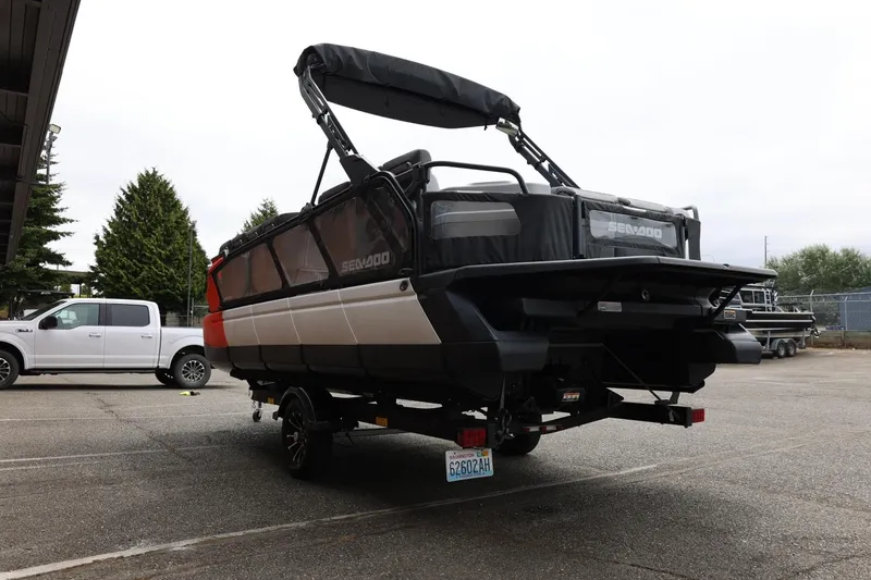 Slide: The Image of 2022 Sea-Doo Switch Cruise 21 on trailer, parked outdoors near a white truck. - 10