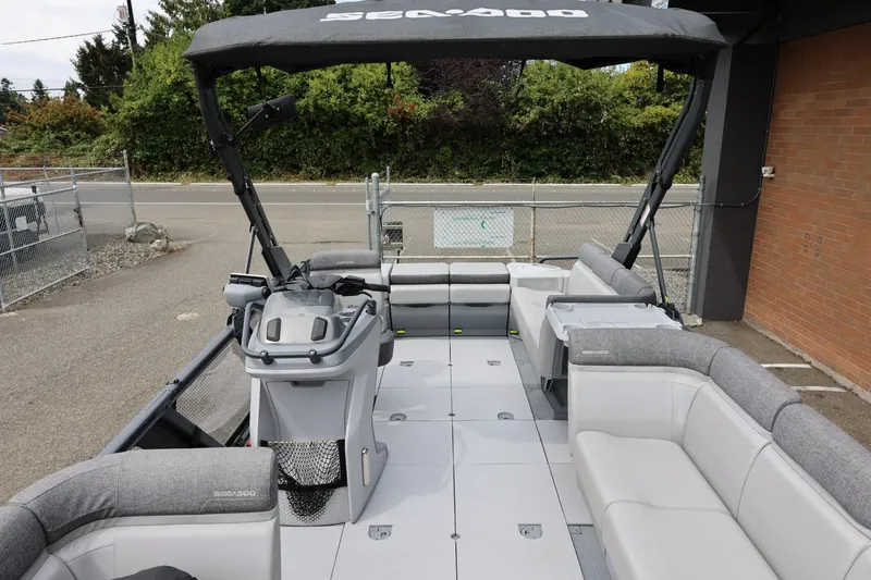 Slide: The Image of 2022 Sea-Doo Switch Cruise 21 pontoon boat interior with spacious seating and helm. - 13