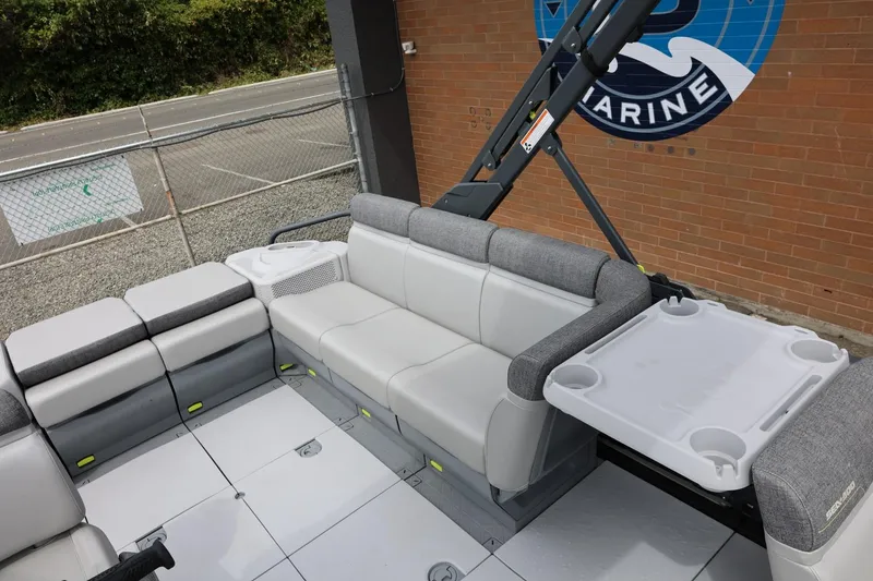 Slide: The Image of 2022 Sea-Doo Switch Cruise 21 interior with gray seating and foldable table. - 19