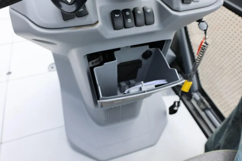 Slide: The Image of Interior console of 2022 Sea-Doo Switch Cruise 21 with open storage compartment. - 26