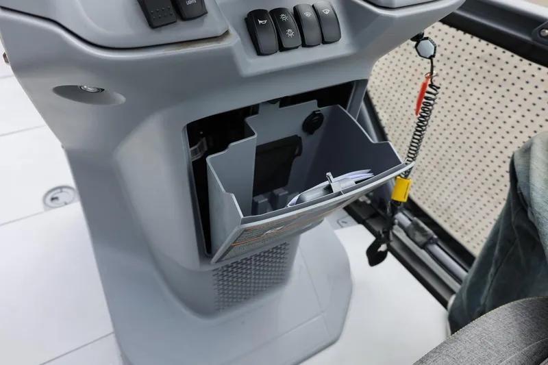 Slide: The Image of 2022 Sea-Doo Switch Cruise 21 dashboard with storage compartment and control switches. - 27