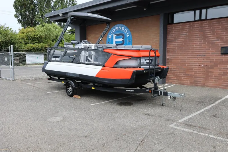Slide: The Image of 2022 Sea-Doo Switch Cruise 21 on trailer, parked outside a building. - 3